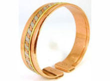 A lovely magnetic bracelet with brass lines and a two colour twist pressed into a plain copper band. Each end is fitted with rare earth magnets